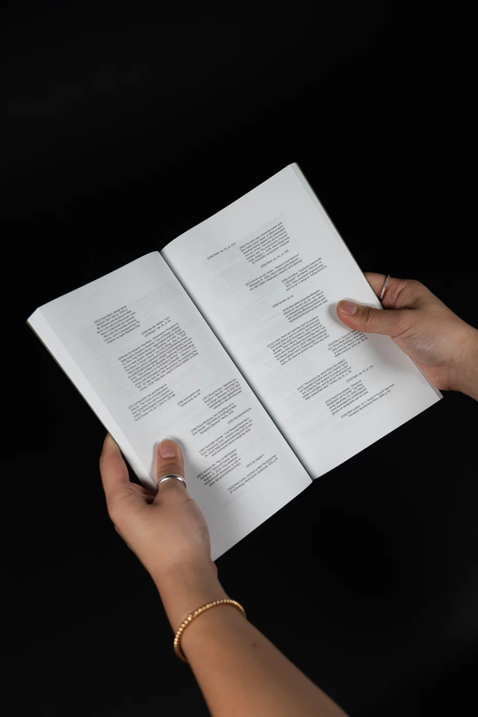 An open spread of body text with epigraphs and footnotes