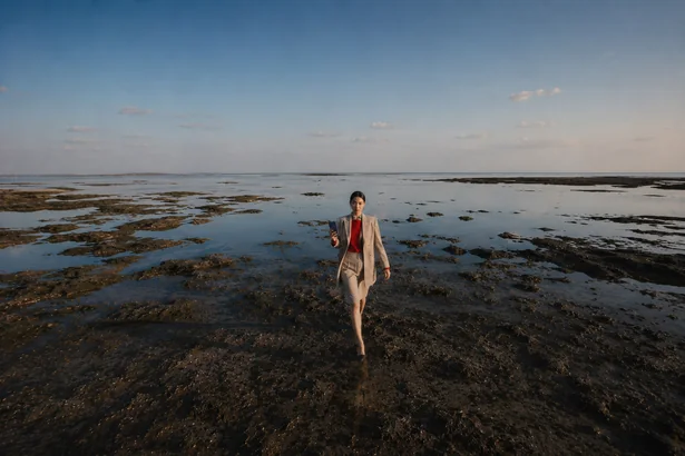 Paper Boat storyboard frame 1: a man at a tidal shore at sunset with a paper boat and a Fold8