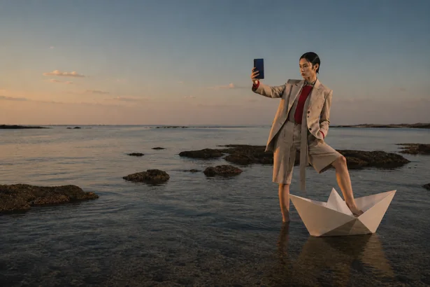 Paper Boat storyboard frame 4: a man at a tidal shore at sunset with a paper boat and a Fold8