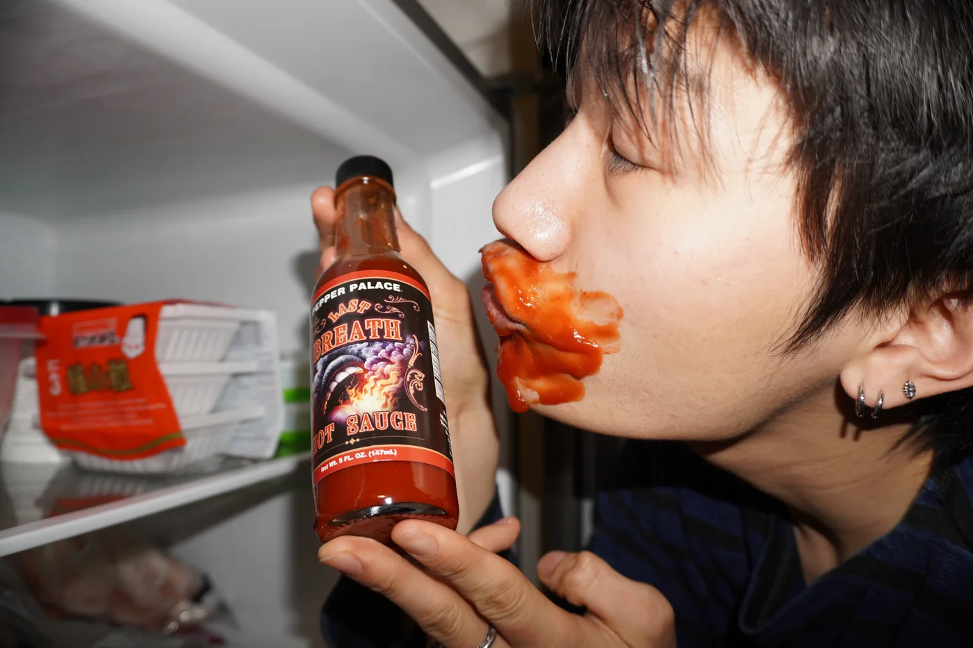 Sauce smeared across the face in front of the shelf