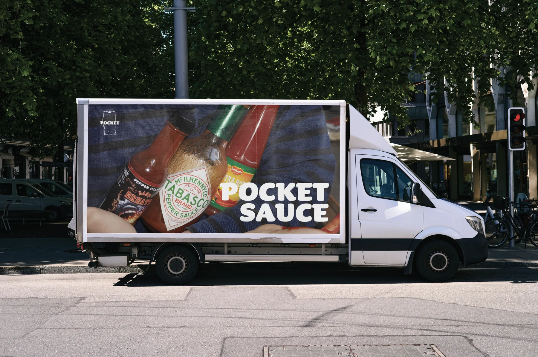 A delivery van wrapped with a close-up photo of hot sauce and the Pocket Sauce logo