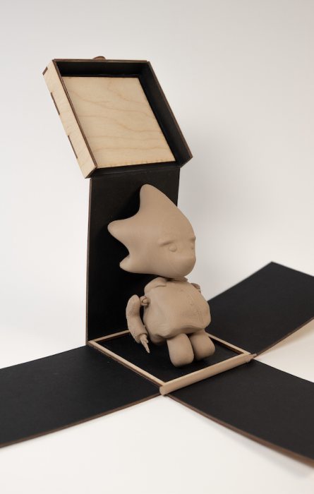 Laser-cut wooden box unfolded to reveal the 3D printed Zeno figure sitting inside